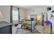 Charming bedroom features a bed with colorful bedding, a desk, and a bright window, creating a cozy space at 15813 Capps Rd, Charlotte, NC 28278
