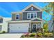 Charming two-story home showcasing a well-maintained front yard with a two car garage and stone accents at 15813 Capps Rd, Charlotte, NC 28278