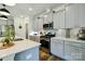 Well-equipped kitchen with stainless steel appliances, gray cabinets, and a spacious countertop island at 15813 Capps Rd, Charlotte, NC 28278