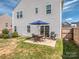 Inviting backyard with a patio seating area, grill, and well-maintained lawn at 1607 Tundra Ln, Denver, NC 28037