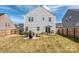 Expansive backyard featuring a patio, fire pit, and lush green lawn at 1607 Tundra Ln, Denver, NC 28037