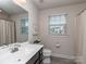 Bathroom with a large mirror and natural light from the window at 1607 Tundra Ln, Denver, NC 28037