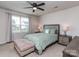 Serene bedroom with a ceiling fan, carpet flooring, a bed, and natural light streaming through the window at 1607 Tundra Ln, Denver, NC 28037