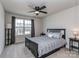 Cozy bedroom featuring a ceiling fan and a large window with neighborhood views at 1607 Tundra Ln, Denver, NC 28037