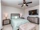 Comfortable bedroom featuring a ceiling fan, bedside tables, a dresser, and a window with natural light at 1607 Tundra Ln, Denver, NC 28037