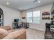 Cozy bonus room with a comfortable couch, desk area, large window, and shelving unit at 1607 Tundra Ln, Denver, NC 28037