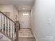 Welcoming foyer featuring a staircase, stylish rug, and views into other rooms at 1607 Tundra Ln, Denver, NC 28037