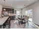 Bright kitchen with stainless steel appliances, dark cabinetry, granite countertops, and a dining area with natural light at 1607 Tundra Ln, Denver, NC 28037