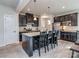 Modern kitchen with a large island, stainless steel appliances, granite countertops, and dark cabinetry at 1607 Tundra Ln, Denver, NC 28037