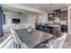 Open-concept kitchen with a center island, granite countertops, dark cabinetry, and seamless flow into the living area at 1607 Tundra Ln, Denver, NC 28037