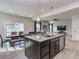 Open-concept kitchen and dining area with stainless steel appliances, granite countertops, and modern lighting at 1607 Tundra Ln, Denver, NC 28037