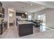 Spacious kitchen with granite counters, stainless appliances, and an open view to dining area and living room at 1607 Tundra Ln, Denver, NC 28037