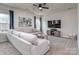 Spacious living room with lots of natural light, a large sectional sofa, and modern entertainment center at 1607 Tundra Ln, Denver, NC 28037
