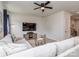 Comfortable living room with a modern ceiling fan, plush sectional sofa, and contemporary decor at 1607 Tundra Ln, Denver, NC 28037