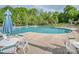 Large community swimming pool surrounded by lush landscaping, chairs and tables at 1607 Tundra Ln, Denver, NC 28037