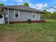 Side view of a single-story home with a brick foundation and green lawn at 1714 Measmer St, Kannapolis, NC 28081