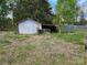 View of a detached garage with a leaning structure and various items scattered around at 1714 Measmer St, Kannapolis, NC 28081