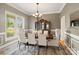 Formal dining room with chandelier, large windows, and vintage china cabinet at 172 Fairway Cir, Rock Hill, SC 29730