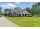 Beautiful brick home with an expansive lawn, mature landscaping and front porch at 172 Fairway Cir, Rock Hill, SC 29730