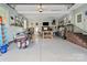 Spacious garage with epoxy flooring, a custom bar, stairs to upper level, and motorcycle parking at 172 Fairway Cir, Rock Hill, SC 29730