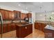 Gourmet kitchen boasts wooden cabinetry, a central island cooktop, and hardwood floors at 172 Fairway Cir, Rock Hill, SC 29730