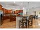 Open kitchen features a breakfast bar, wooden cabinets, stainless steel appliances, and hardwood floors at 172 Fairway Cir, Rock Hill, SC 29730