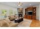 Inviting living room featuring a stone fireplace and hardwood floors with a plush rug at 172 Fairway Cir, Rock Hill, SC 29730