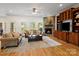 Inviting living room features a stone fireplace, hardwood floors and custom wood entertainment center at 172 Fairway Cir, Rock Hill, SC 29730