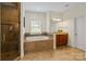 Spacious main bathroom offers a tub, glass shower, vanity and tiled flooring at 172 Fairway Cir, Rock Hill, SC 29730