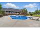 Inviting backyard pool area with diving board, surrounded by lush greenery and palm trees at 172 Fairway Cir, Rock Hill, SC 29730