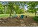 Charming backyard with a cozy fire pit area surrounded by comfortable seating and lush greenery, perfect for outdoor gatherings at 176 Jennymarie Rd, Mooresville, NC 28115