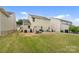 Generous backyard showcases a patio with seating, a lounge area, and plenty of lawn space, offering great outdoor living at 176 Jennymarie Rd, Mooresville, NC 28115