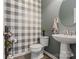 Half bath features gray and white wallpaper and pedestal sink at 176 Jennymarie Rd, Mooresville, NC 28115