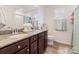 Bathroom showcasing a vanity with granite countertop, dual sinks, toilet, and shower with curtain at 176 Jennymarie Rd, Mooresville, NC 28115
