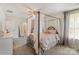 Bright bedroom with a canopy bed, plush carpet, and soft, neutral decor creating a cozy retreat at 176 Jennymarie Rd, Mooresville, NC 28115