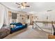 Upstairs bonus room area featuring a comfortable sofa, daybed, and neutral decor at 176 Jennymarie Rd, Mooresville, NC 28115