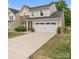 Traditional home with a two-car garage, manicured lawn, and neutral exterior colors at 176 Jennymarie Rd, Mooresville, NC 28115