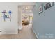 Open hallway leading to a cozy living room with comfortable seating and warm lighting at 176 Jennymarie Rd, Mooresville, NC 28115