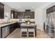 Charming kitchen featuring dark cabinets, granite countertops, and an island at 176 Jennymarie Rd, Mooresville, NC 28115