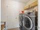 Well-organized laundry room features modern washer, dryer and storage baskets, maximizing space and convenience at 176 Jennymarie Rd, Mooresville, NC 28115