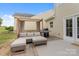 Charming patio area features a comfortable lounge set and a barbecue grill, perfect for outdoor entertaining and relaxation at 176 Jennymarie Rd, Mooresville, NC 28115