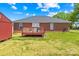 A well-maintained brick home in the backyard features a deck and a shed with a spacious lawn and blue skies at 201 Churchill Dr, Kings Mountain, NC 28086