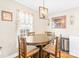 Inviting dining area with a wooden table set, window views, and attractive lighting fixture at 201 Churchill Dr, Kings Mountain, NC 28086