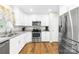 Bright kitchen with granite countertops, stainless steel appliances, and hardwood floors at 201 Churchill Dr, Kings Mountain, NC 28086