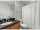Bathroom featuring a white shower curtain and wood vanity at 2304 Thunder Gulch Ct, Waxhaw, NC 28173