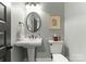 Charming bathroom featuring modern fixtures, a pedestal sink, and toilet at 2304 Thunder Gulch Ct, Waxhaw, NC 28173