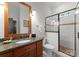 Elegant bathroom with granite countertops, glass shower, and a modern vanity with wood cabinets at 2304 Thunder Gulch Ct, Waxhaw, NC 28173