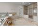 Luxurious bathroom featuring a tub, glass shower, tile flooring, and a double vanity at 2304 Thunder Gulch Ct, Waxhaw, NC 28173