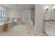 Serene bathroom with a soaking tub, walk-in shower, tile floors, and double doors at 2304 Thunder Gulch Ct, Waxhaw, NC 28173