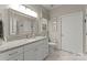 Bright bathroom with white cabinets, granite countertop, large mirror, and tiled floor at 2304 Thunder Gulch Ct, Waxhaw, NC 28173